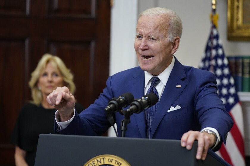 President Biden speaks at a lectern 