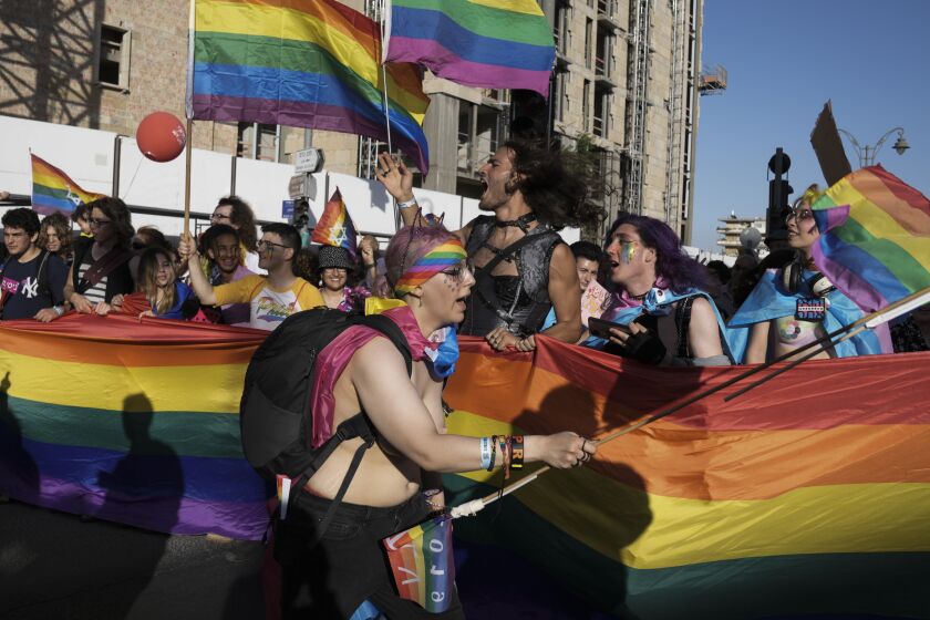 Participants march in the annual Pride Parade in Jerusalem, Thursday, June 2, 2022. Thousands of people marched in the parade through the streets of Jerusalem under heavy security over fears of extremism. (AP Photo/Maya Alleruzzo)