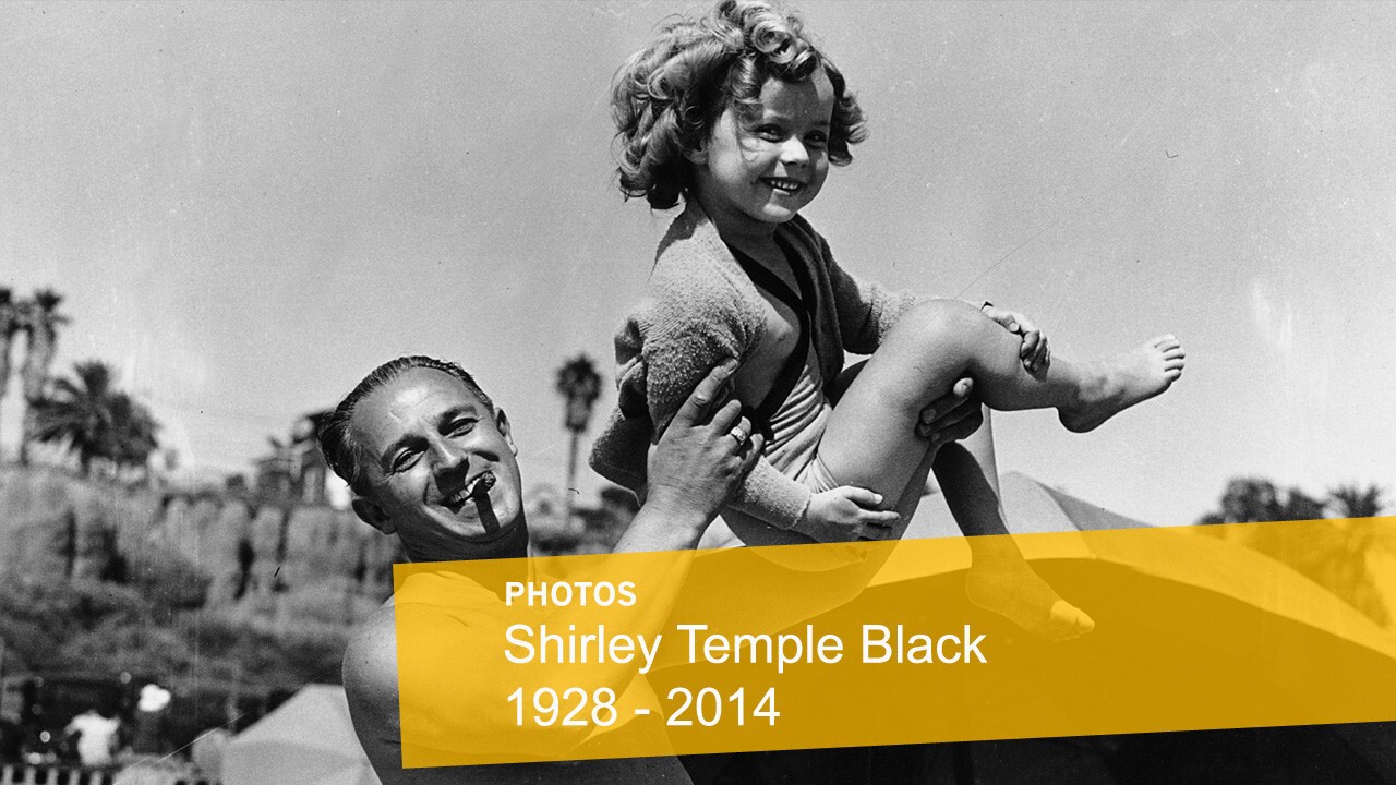Shirley Temple is shown with her father, George F. Temple, as they enjoy a day at the beach at the Santa Monica Athletic Club in Santa Monica.