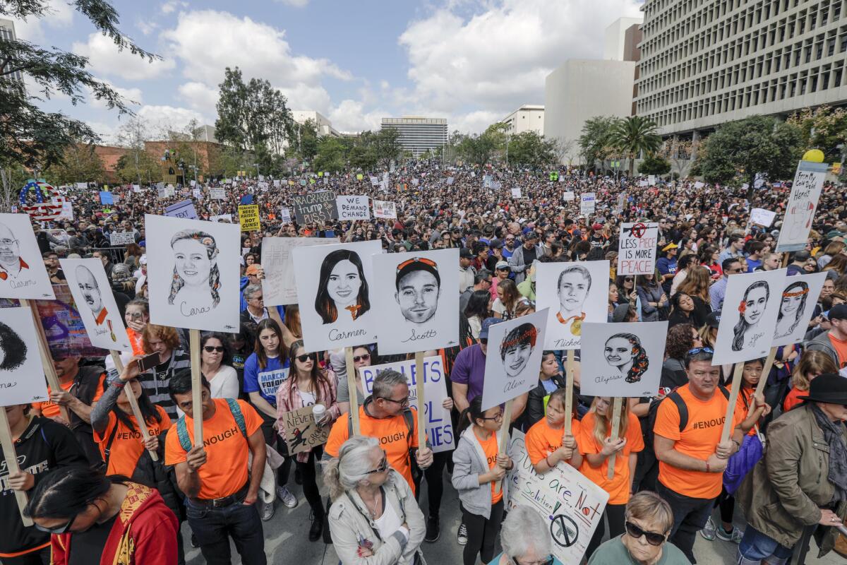 Marchers carry portraits of the 17 who were killed in the Parkland, Fla. shooting. The portraits were drawn by Gracie Pekrul, 16, a student of Simi Valley Oak Park Independent School.