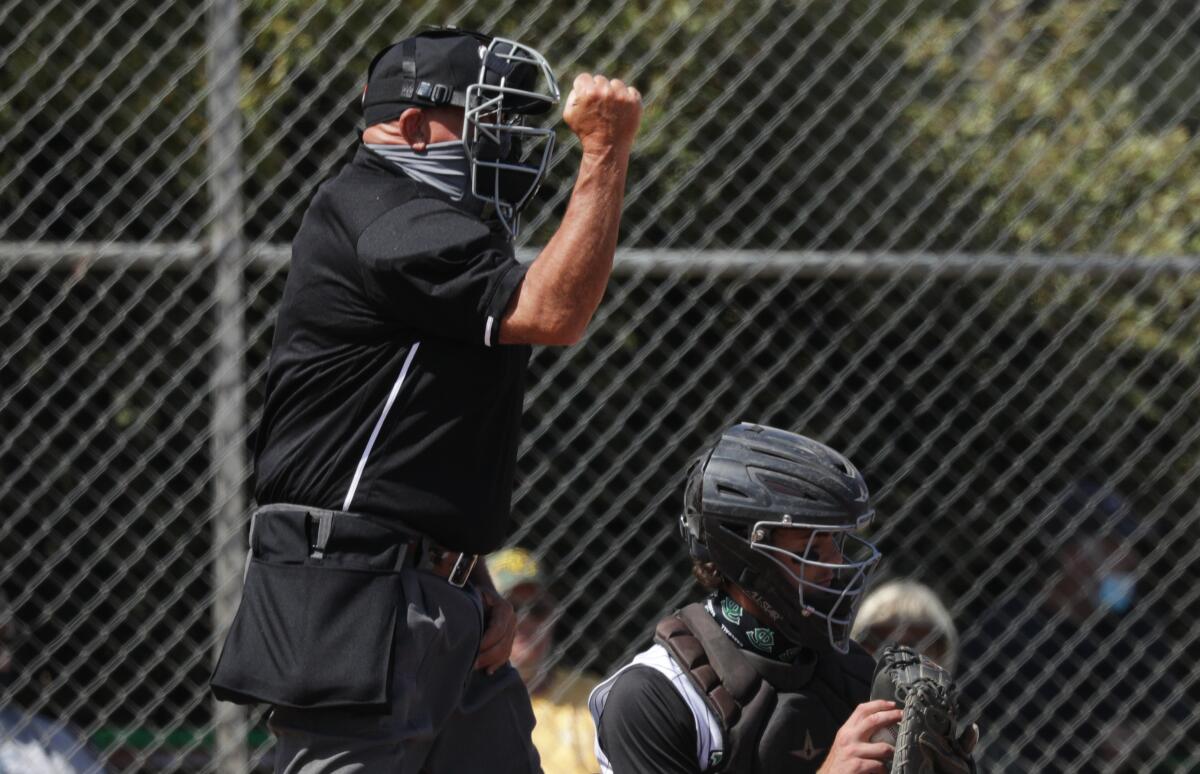 Plate umpire Jeff Sill calls a strike during a game between Thousand Oaks and Newbury Park on May 17.