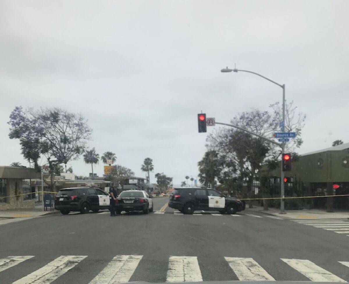 Police gather on Pearl Street at Draper Avenue to investigate the deadly shooting that took place around 12:39 a.m. June 23, 2019 in the alley of 7500 Cuvier Street in La Jolla.