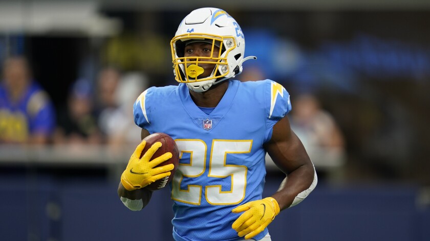  Chargers running back Joshua Kelley arms up before a preseason game.