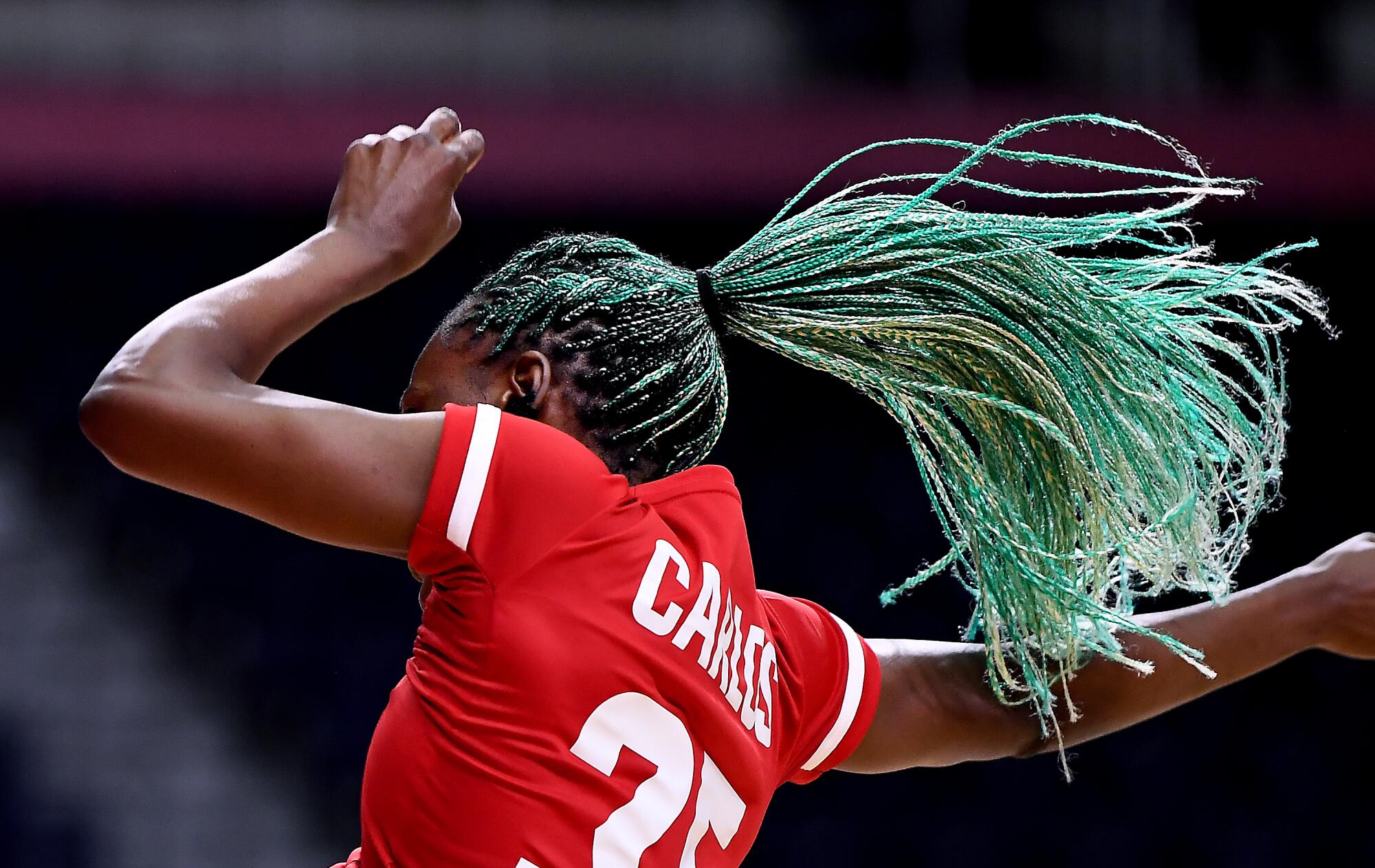 The hair of Angola's Azenaide Carlos flies through the air after taking a shot against Netherlands