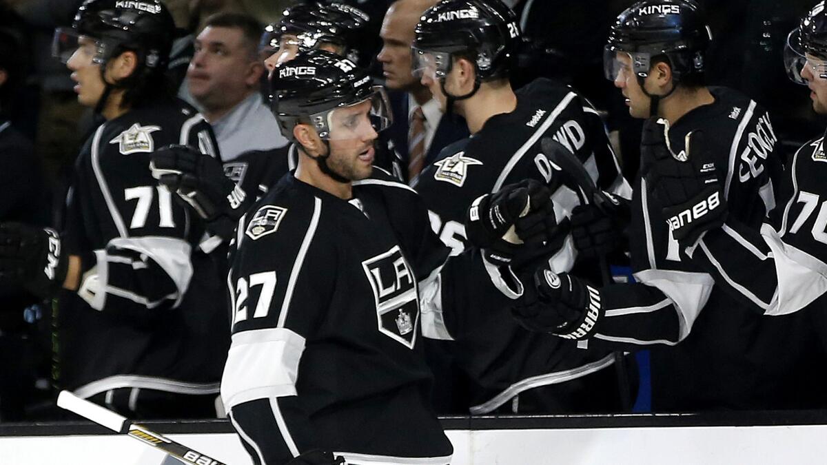 Kings defenseman Alec Martinez is congratulated by teammates on the bench after scoring against the Islanders during the first period Wednesday.