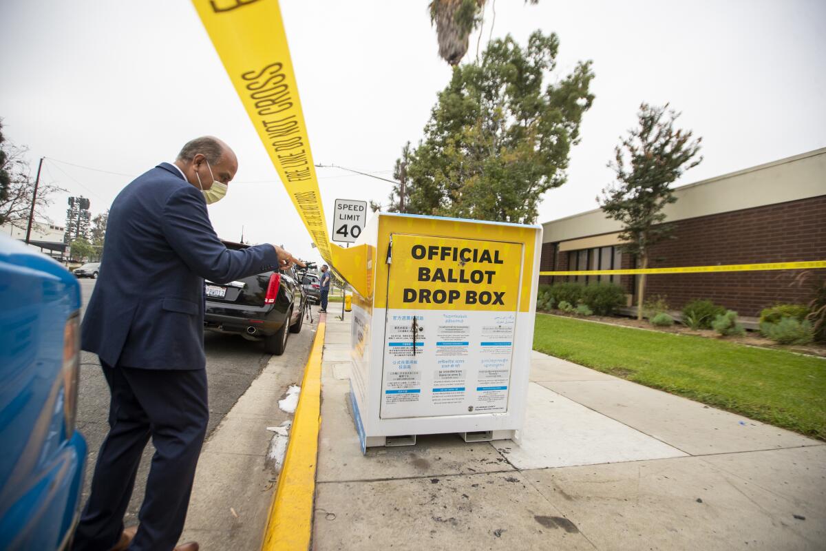 Baldwin Park Mayor Manuel Lozano views the fire damage to a ballot drop box.