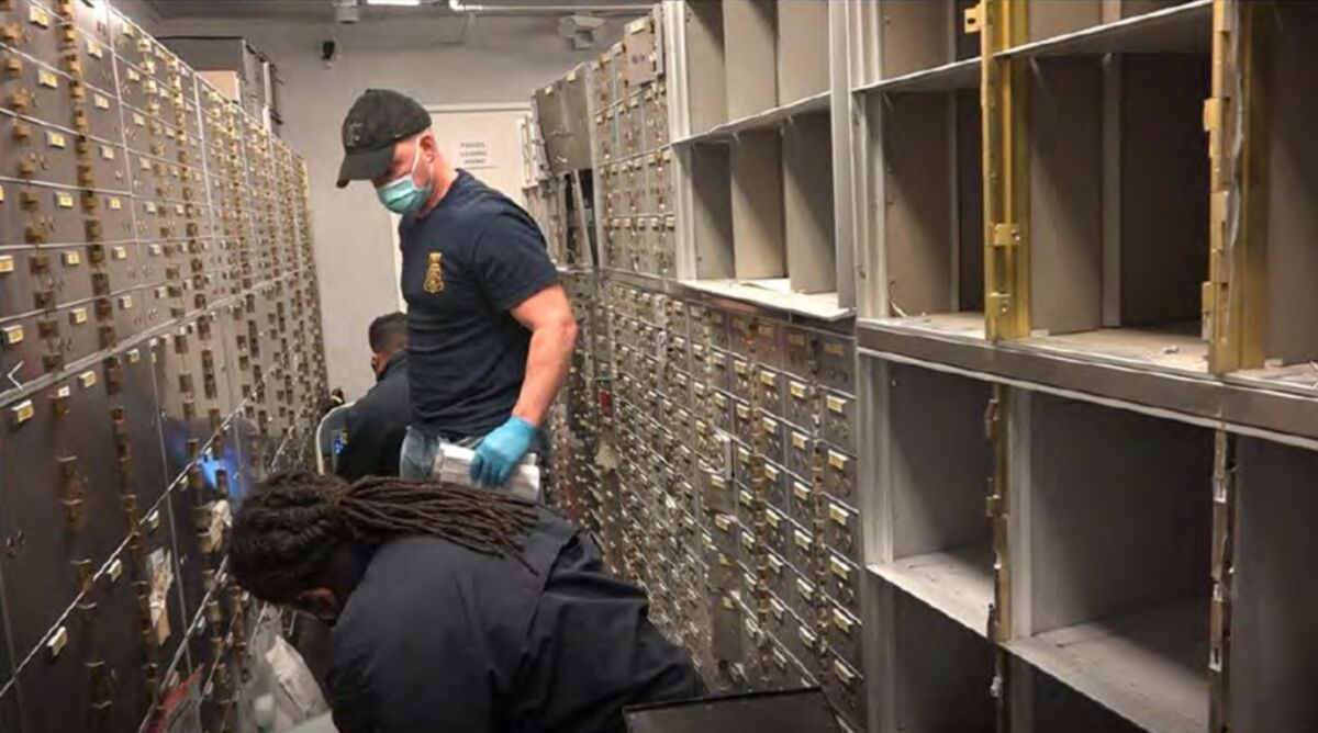 Federal agents removing safe deposit boxes from the walls