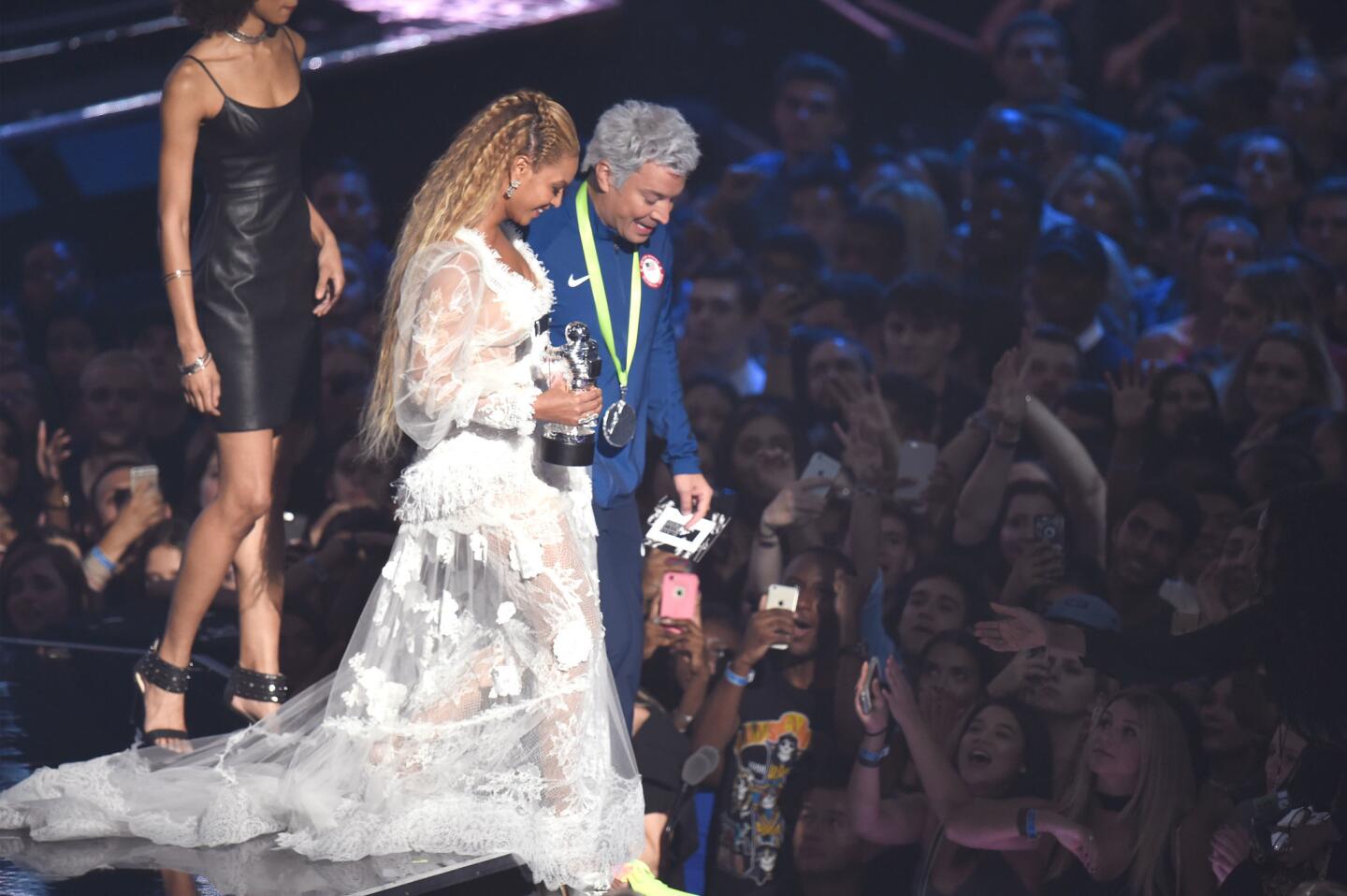 Jimmy Fallon, as Olympian swimmer Ryan Lochte, helps Beyoncé walk in her dress after presenting her with video of the year for "Formation" onstage during the 2016 MTV Video Music Awards at Madison Square Garden in New York.