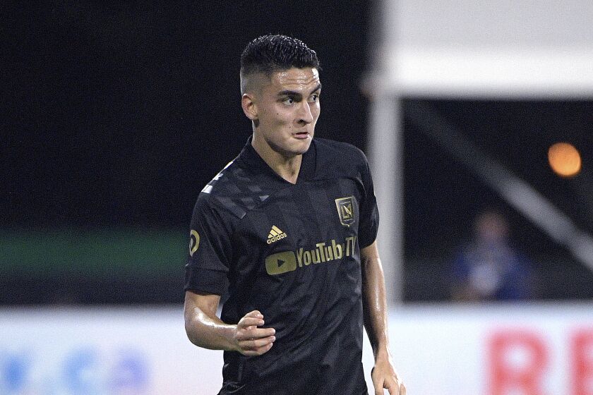 Los Angeles FC midfielder Eduard Atuesta (20) sets up a play during the second half of an MLS soccer match against the Portland Timbers, Thursday, July 23, 2020, in Kissimmee, Fla. (AP Photo/Phelan M. Ebenhack)