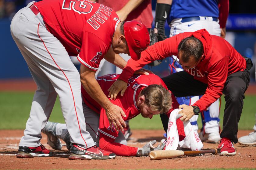 TORONTO, ON - JULY 29: Taylor Ward #3 of the Los Angeles Angels is helped after being hit by a pitch.