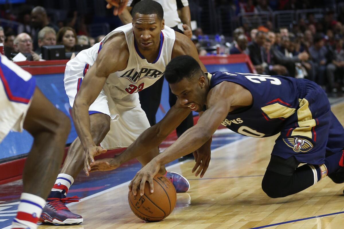 Pelicans guard Norris Cole beats Clippers forward Wesley Johnson to a loose ball during the second half.