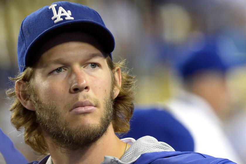 Dodgers pitcher Clayton Kershaw looks on from the dugout during a game against the San Francisco Giants in September.