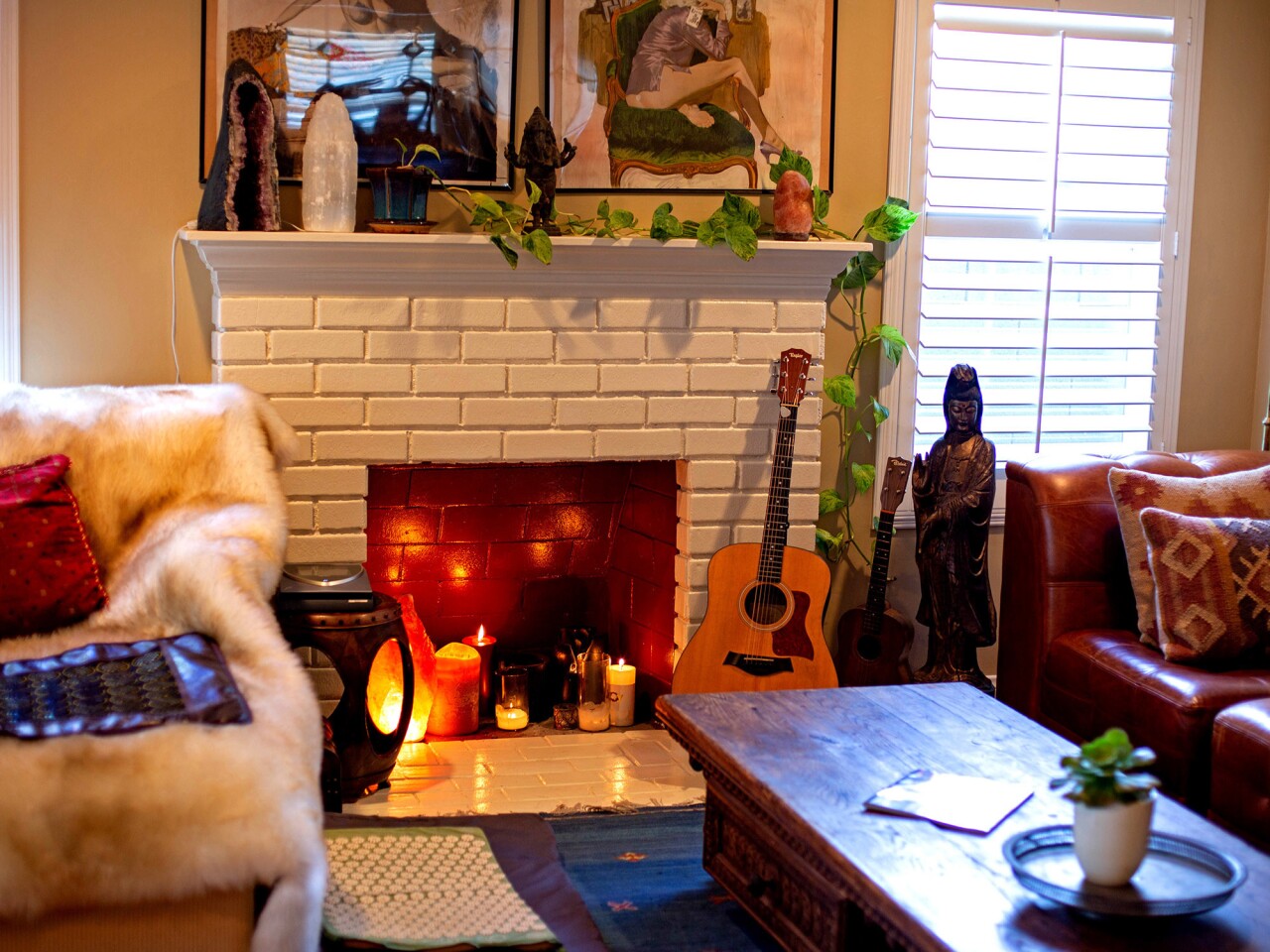 The inviting space has Buddha and Ganesh statues arrayed on shelves and pillar candles flickering in a white-brick fireplace. It harbors his Taylor guitar and upright piano, as well as a snowy faux-fur throw atop a deep sofa, in a soothing cognac shade.