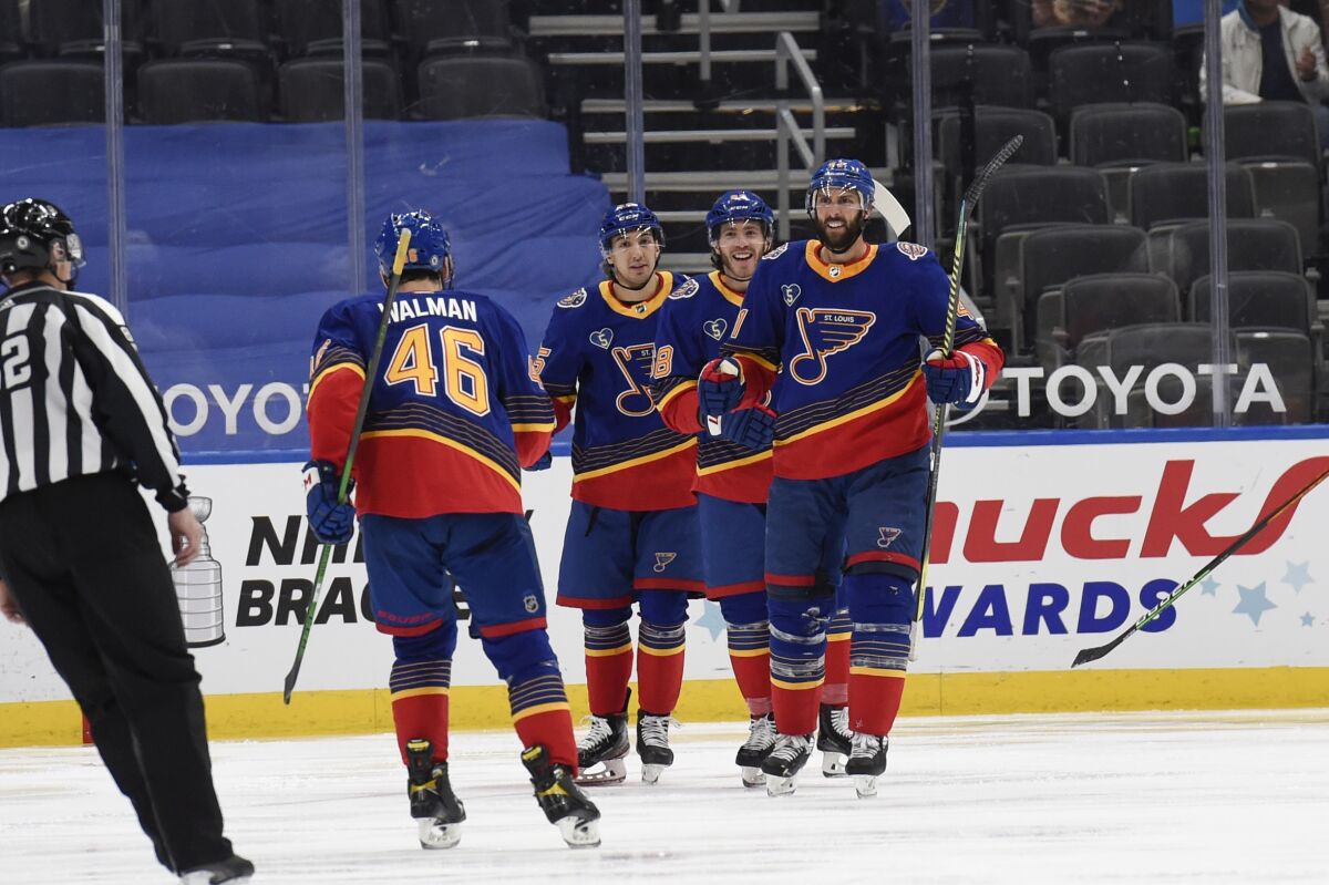 St. Louis Blues' Robert Bortuzzo (41) is congratulated by teammates after scoring a goal against the Anaheim Ducks during the third period of an NHL hockey game on Monday, May 3, 2021, in St. Louis. (AP Photo/Joe Puetz)