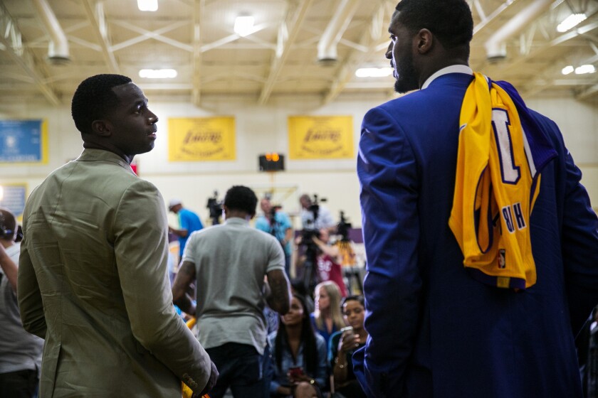 Brandon Bass, a 6-foot-8 forward, chats with 7-2 center Roy Hibbert after the Lakers' introductory news conference on Wednesday in El Segundo.