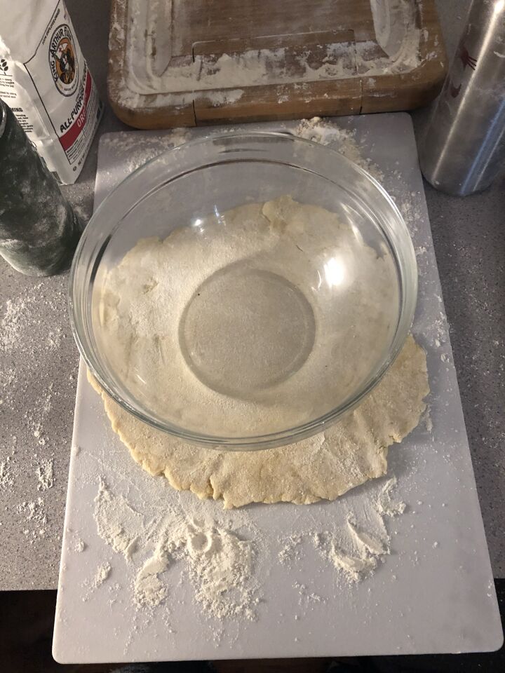 Measuring the size of my rolled dough before placing it in the "pie tin," which was really a large glass bowl