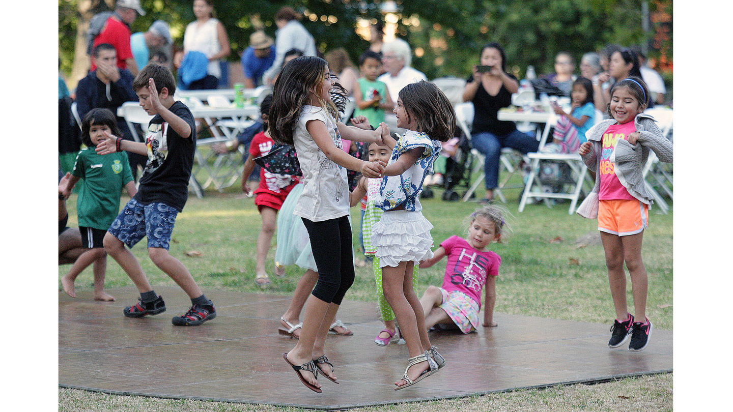 Montrose residents Nissa Nadjarians, 9, and Lauren Lara, 7, dance together at Verdugo Park Wednesday listening to 80s music by the band the Reflexx.