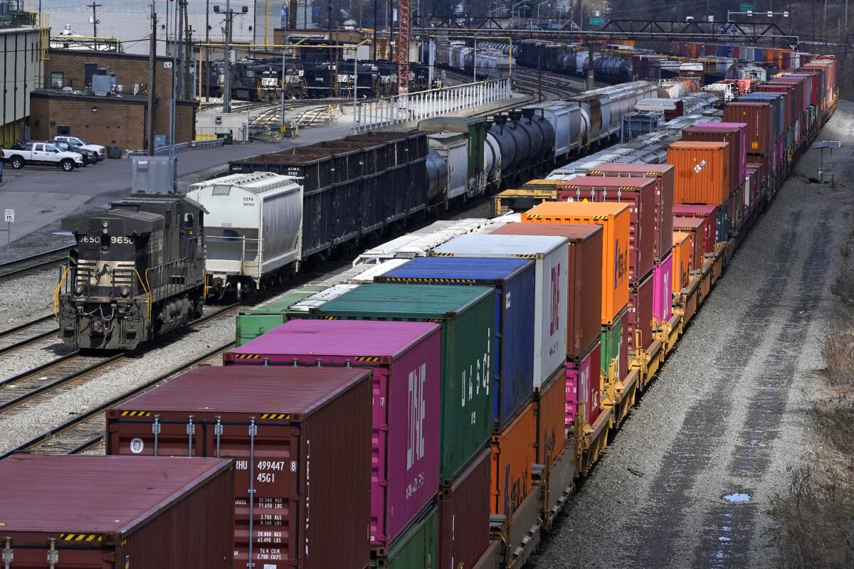 Freight train cars and containers at a railyard.