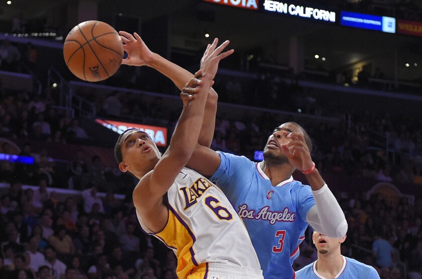 Clippers point guard Chris Paul (3) fouls Lakers counterpart Jordan Clarkson during the first half Sunday at Staples Center.