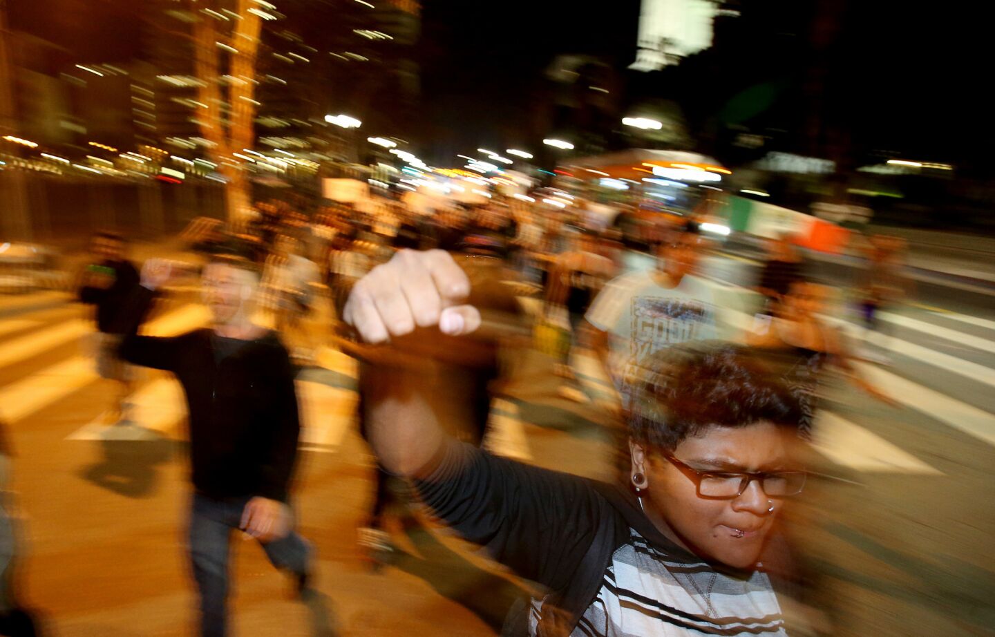 Demonstrators march down Spring Street in L.A. to protest President-elect Donald Trump on Thursday night.