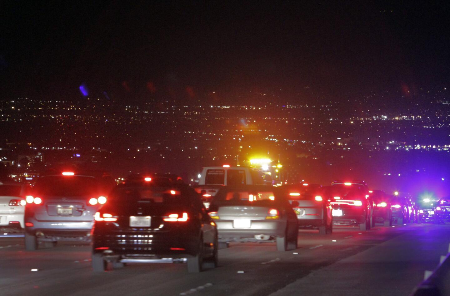 Cars stream north on the 405, ahead of schedule, over the Sepulveda Pass on Sunday night.