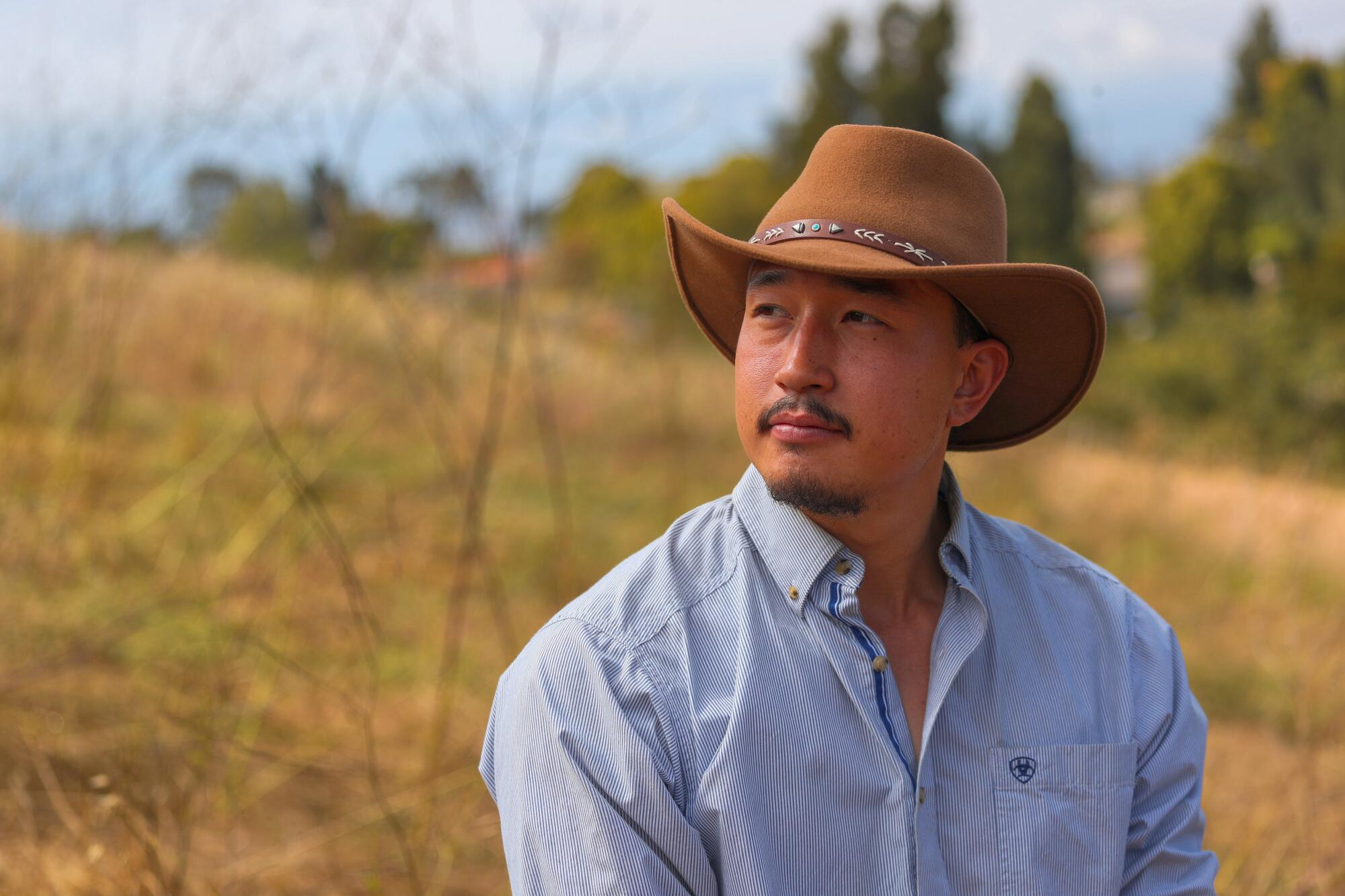 Goat herder Michael Choi wearing a cowboy hat