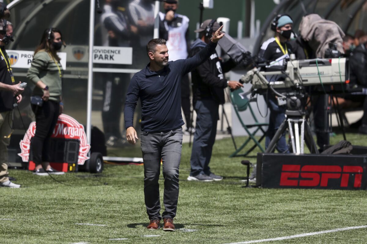 Galaxy coach Greg Vanney signals to players during a loss to the Timbers 