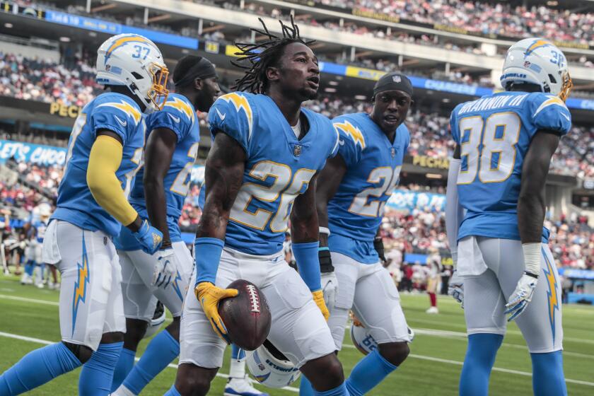 Inglewood, CA, Sunday, August 22, 2021 - Los Angeles Chargers cornerback Asante Samuel Jr. (26) celebrates with teammates after a first quarter interception against San Francisco 49ers quarterback Jimmy Garoppolo (10) at SoFi Stadium. (Robert Gauthier/Los Angeles Times)