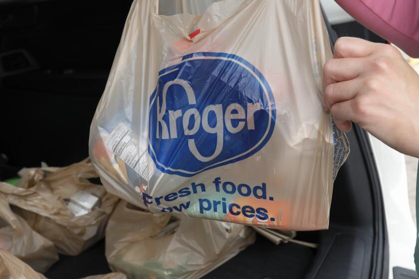 FILE - A customer removes her purchases at a Kroger grocery store in Flowood, Miss., Wednesday, June 26, 2019. Don't count on a favorite store being open on Easter Sunday. Several stores will be closed March 31, 2024, in observance of the holiday. (AP Photo/Rogelio V. Solis, File)