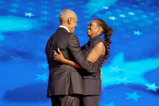 DNC CHICAGO, IL AUGUST 20, 2024 - Former President Barack Obama, left, embraces his wife former first lady Michelle Obama on stage during the Democratic National Convention Tuesday, Aug. 20, 2024, in Chicago. (Robert Gauthier/Los Angeles Times)