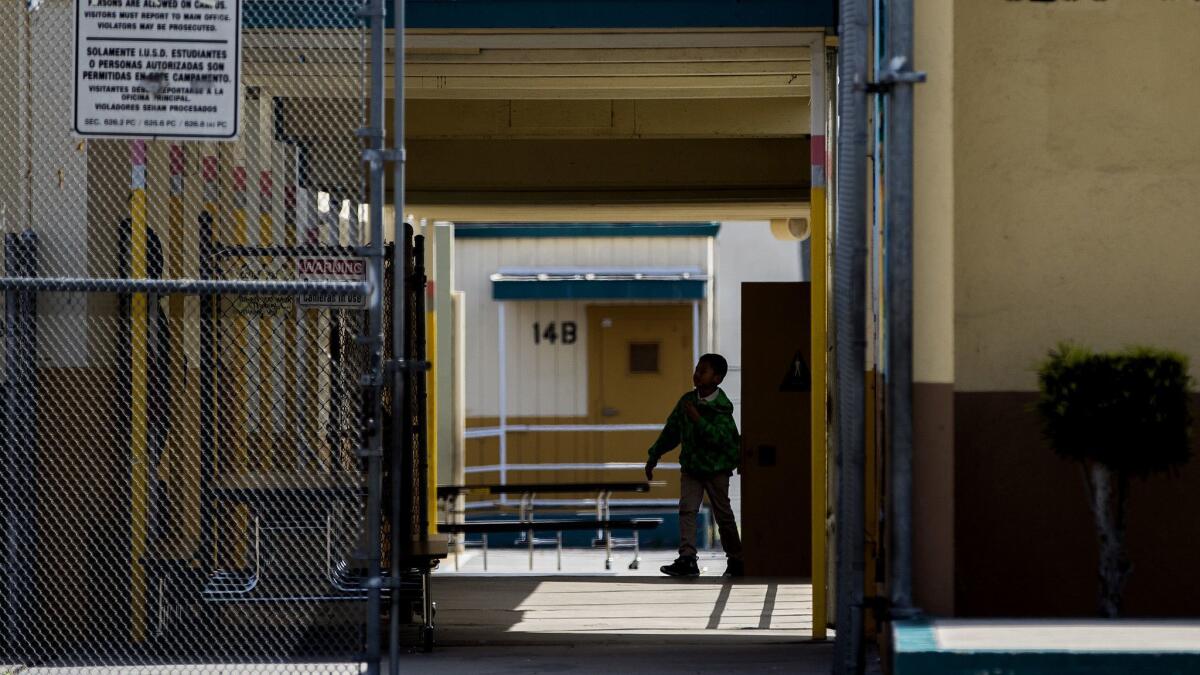 A student walks between classrooms at the end of the school day at Clyde Woodworth Elementary School in Inglewood, Calif. on April 5.
