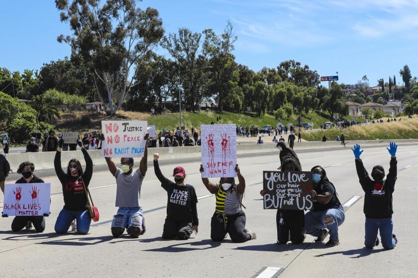 Protestors in support of calling for justice for George Floyd temporary blocked the westbound freeway lanes on Int. 8 during a protest in La Mesa on Saturday.