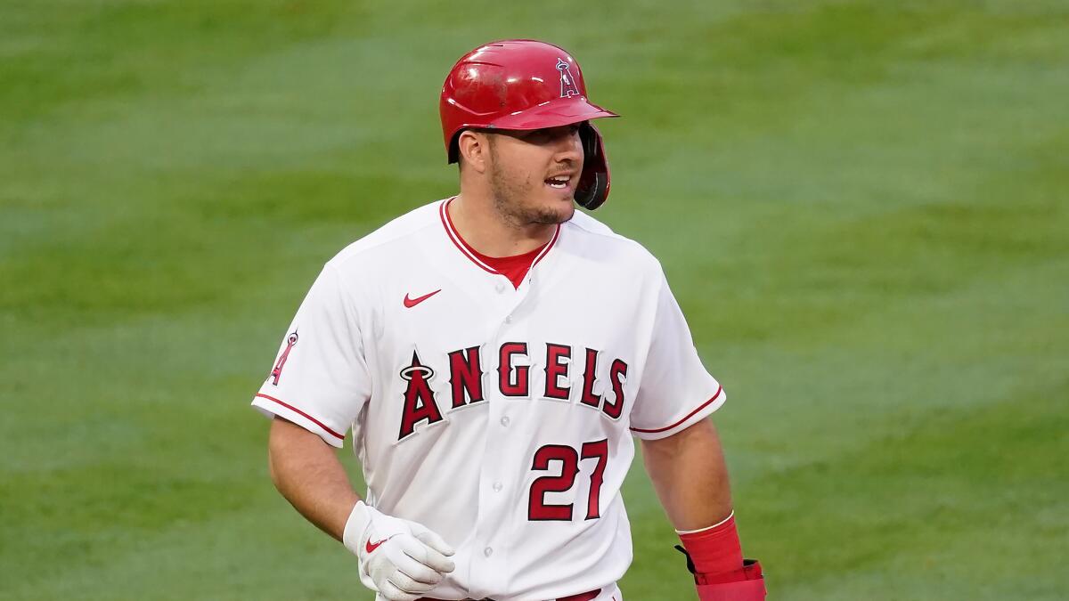Los Angeles Angels' Mike Trout (27) walks back to first base during the first inning.