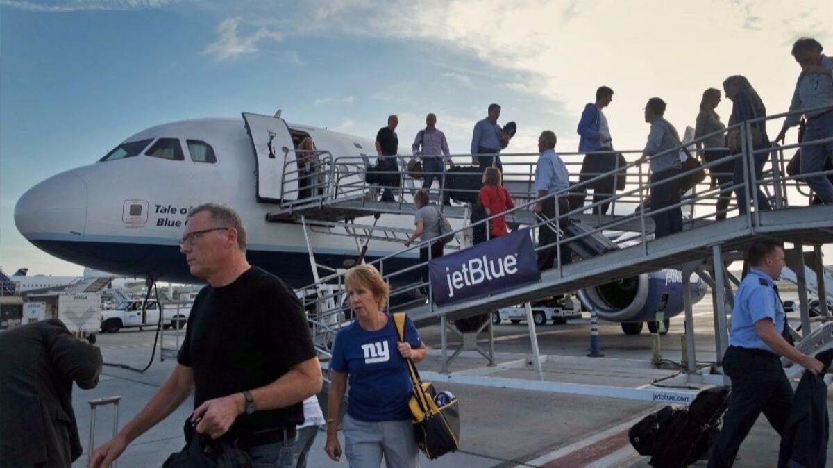 Passengers arrive at Long Beach Airport on a JetBlue Airways plane from New York. Passenger volume jumped nearly 50% in the past six months at the airport.