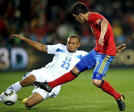 Spain striker David Villa, right, is challenged for the ball by Honduras defender Sergio Mendoza during a World Cup Group H match at Ellis Park Stadium in Johannesburg, South Africa, on Monday.