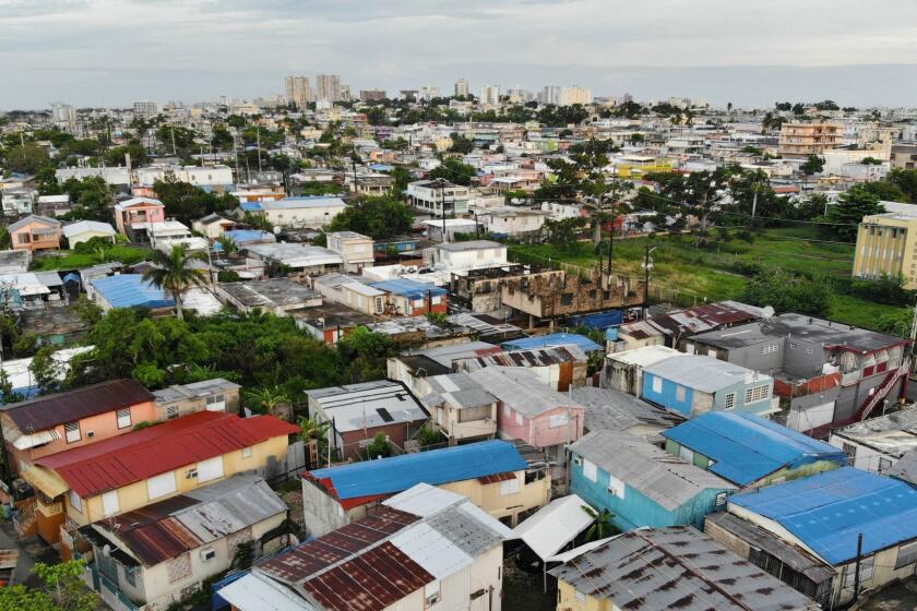 SAN JUAN, PUERTO RICO-SEPT. 13, 2018--A view of the plastic tarps in the Barrio Obrero area of San Juan, where many homes have not been repaired after one year. One year after Hurricane Maria devastated Puerto Rico some residents are still trying to recover. (Carolyn Cole/Los Angeles Times)