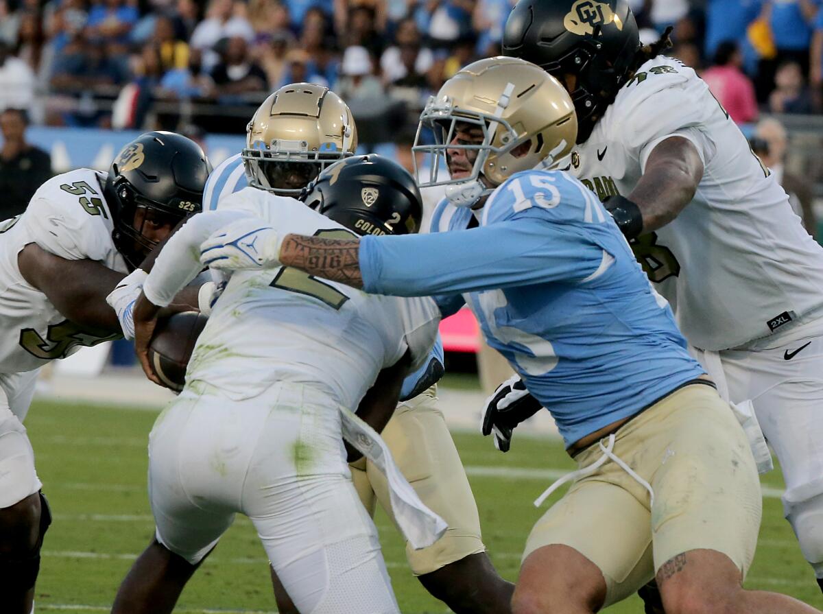 UCLA defensive end Laiatu Latu sacks Colorado quarterback Shedeur Sanders at the Rose Bowl.