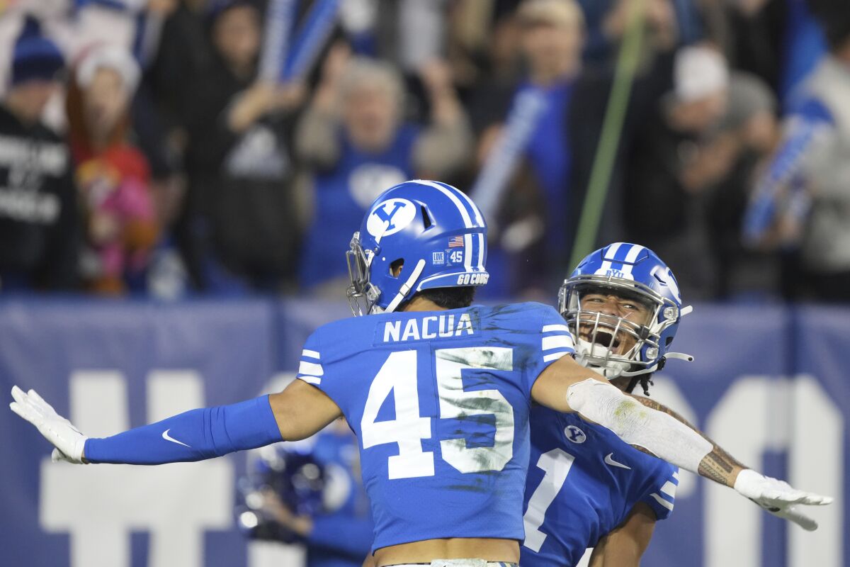 BYU wide receiver Samson Nacua (45) and BYU wide receiver Keanu Hill (1) celebrate a touchdown during the first half of the team's NCAA college football game against Virginia on Saturday, Oct. 30, 2021, in Provo, Utah. (AP Photo/George Frey)