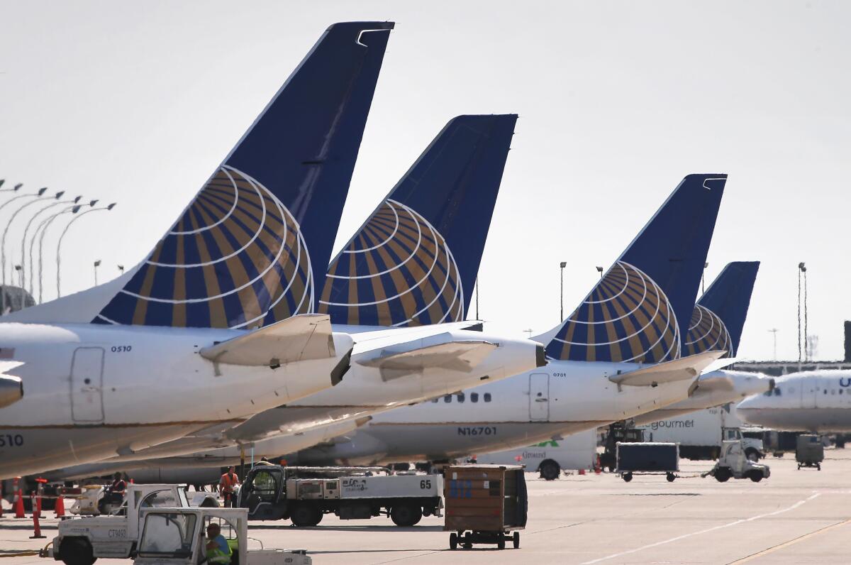 United Airlines jets sit at gates at O'Hare International Airport in Chicago. The carrier has changed its program for unaccompanied minors.