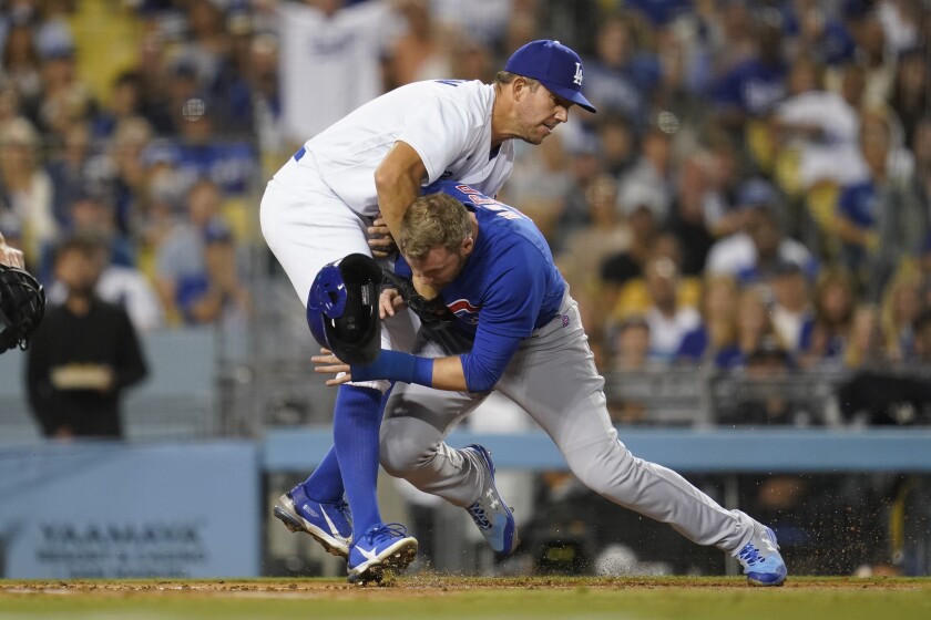 Dodgers pitcher Tyler Anderson tags Cubs' Ian Happ on home plate in the sixth inning on July 8, 2022. 