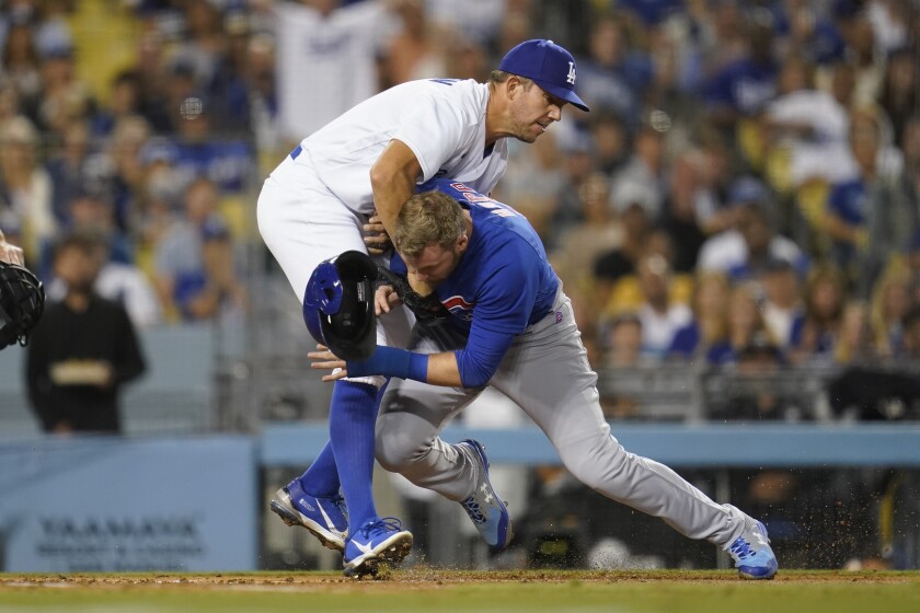 Dodgers pitcher Tyler Anderson tags out the Cubs' Ian Happ at home plate in the sixth inning July 8, 2022.