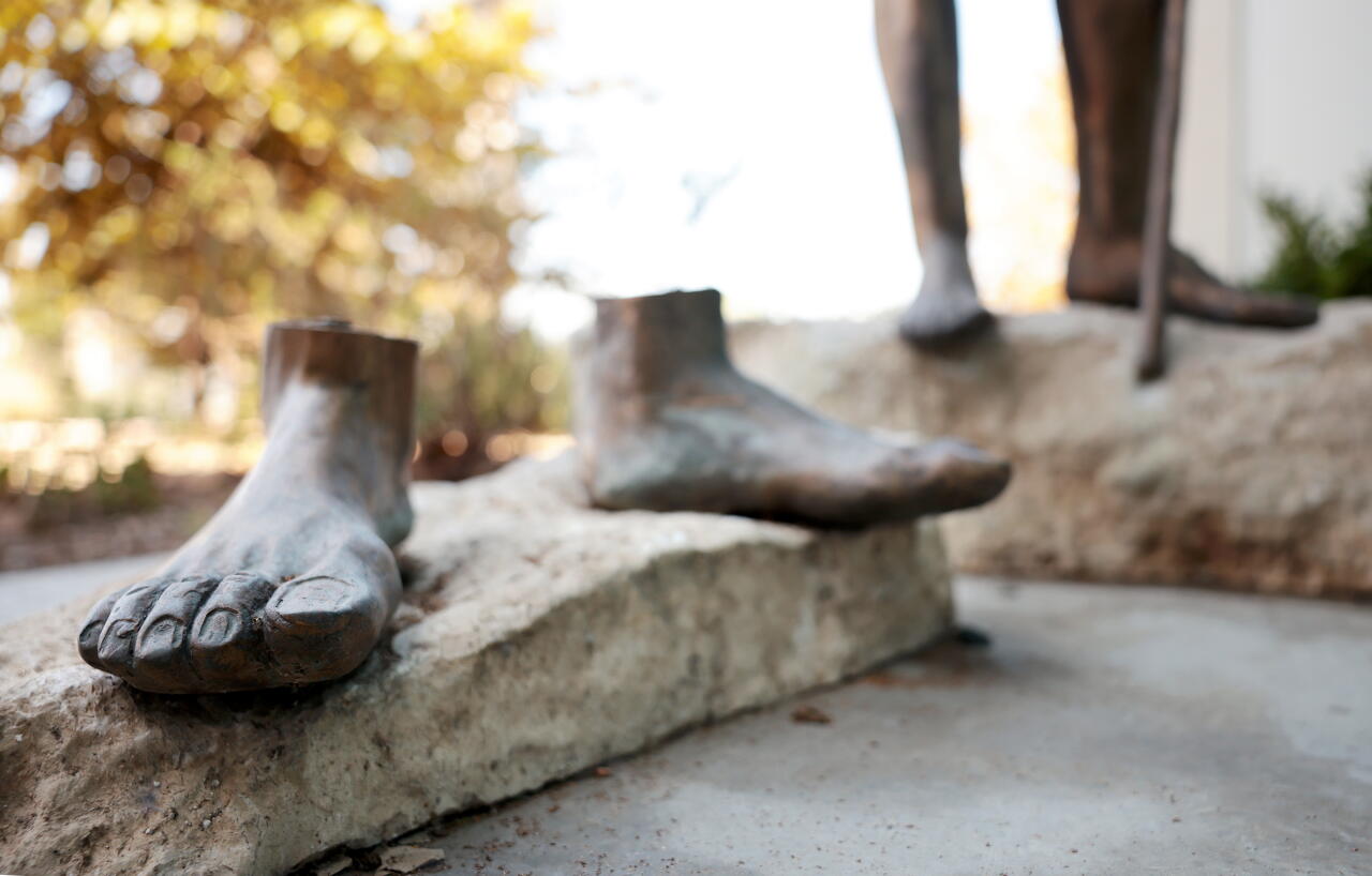 A bronze statue of Jesus was cut from its base beside a statue of St. John the Baptist