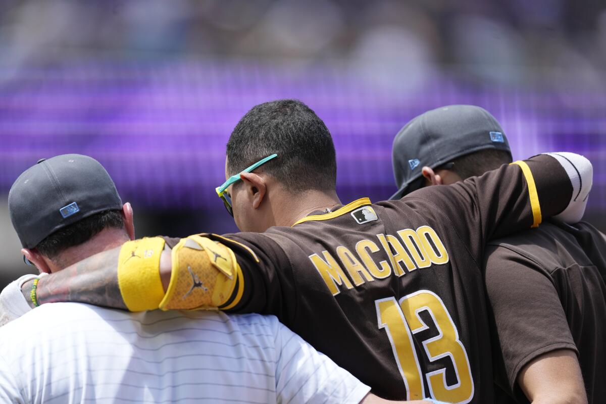 The San Diego Padres' Manny Machado is congratulated by teammate