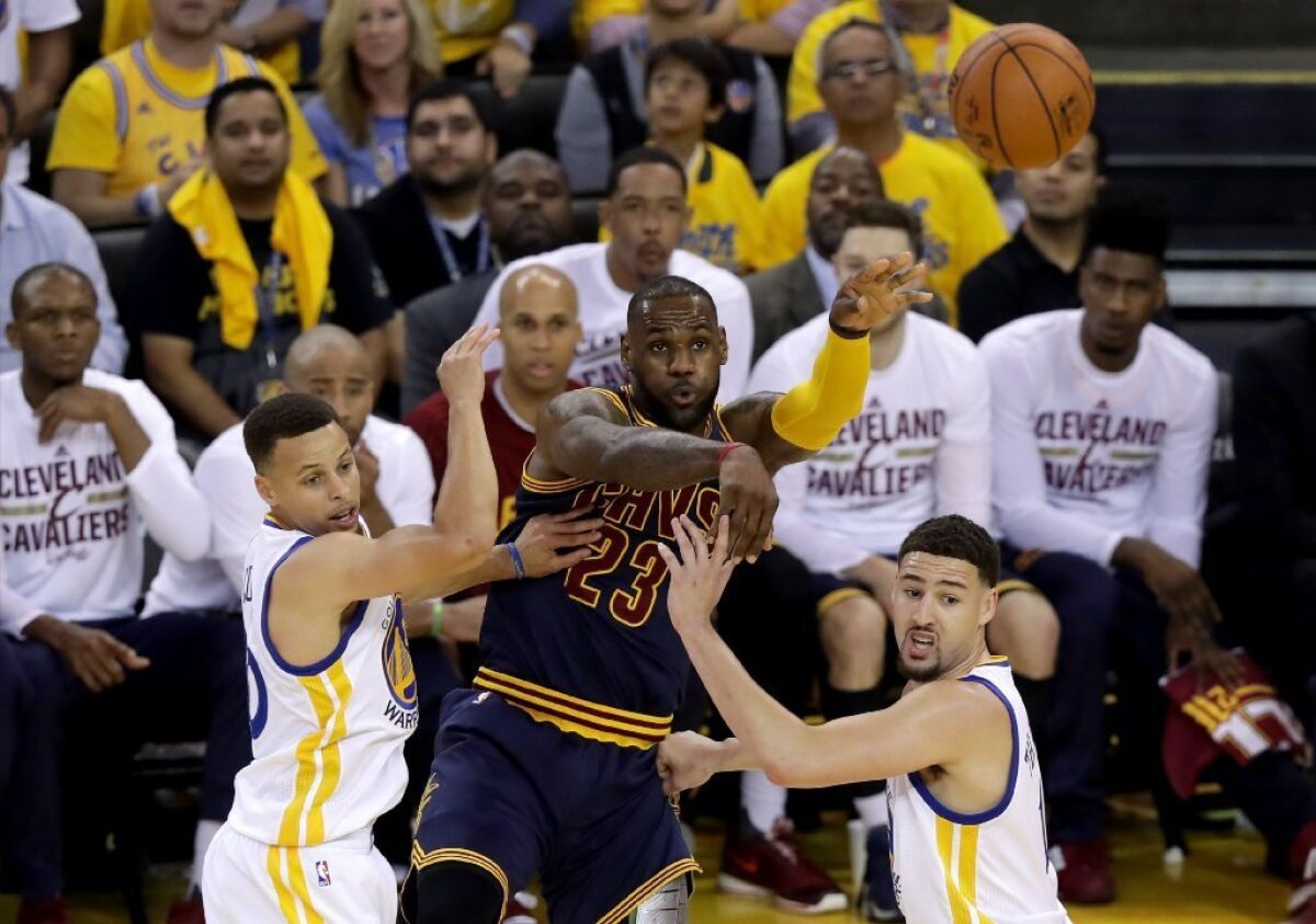Warriors guards Stephen Curry and Klay Thompson double team Cavaliers forward LeBron James during Game 1 of the NBA Finals on June 2.