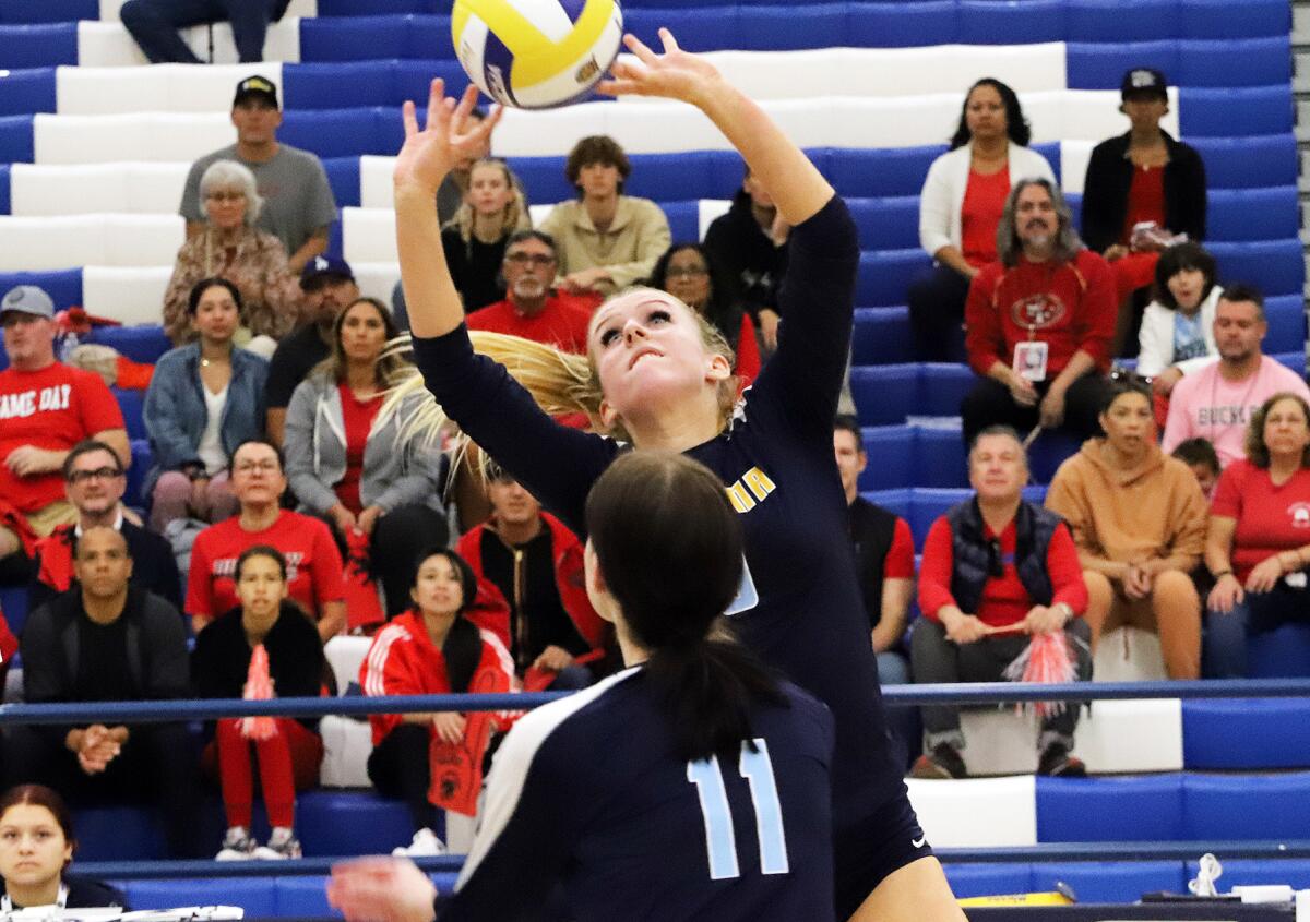 Marina's Jordan Packer (9) sets up Lyndsey Wessel (11) in a girls' volleyball final at Cerritos College.