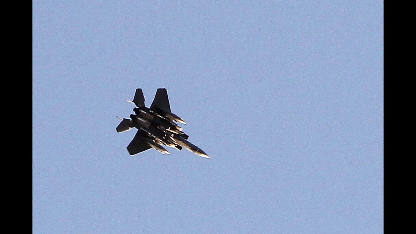 A U.S.-led coalition aircraft flies over Kobani, Syria.