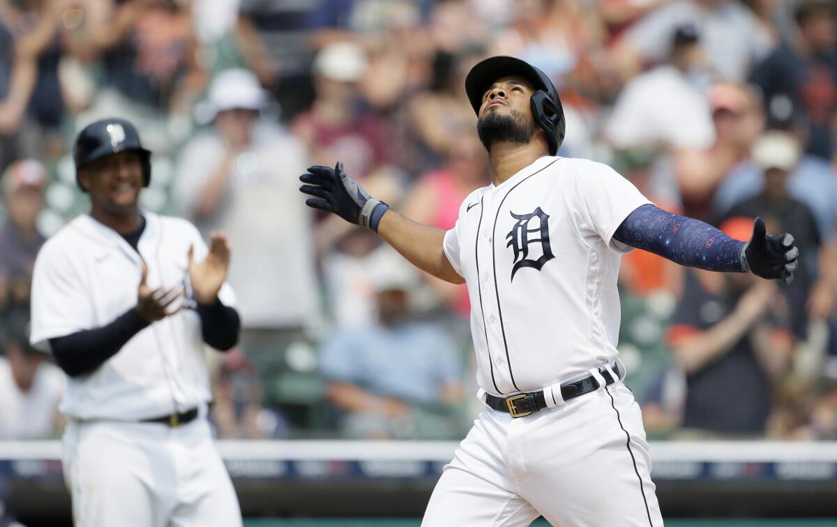Detroit Tigers' Jeimer Candelario celebrates his two-run home run against the Minnesota Twins that also scored Jonathan Schoop, left, during the seventh inning of a baseball game Sunday, July 18, 2021, in Detroit. (AP Photo/Duane Burleson)