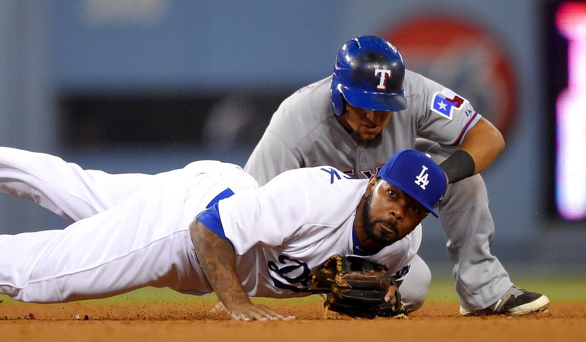 Texas Rangers' Rougned Odor is forced out at second as Dodgers second baseman Howie Kendrick throws out Carlos Corporan at first during the seventh inning on Wednesday.