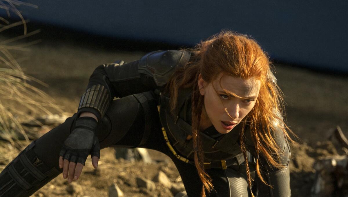 Scarlett Johansson looks up from a crouched position in the movie "Black Widow."