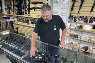 John Parkin, co-owner of Coyote Point Armory displays a handgun at his store in Burlingame, Calif., Thursday, June 23, 2022. California's top law enforcement official said that he is working with the governor and legislative leaders on legislation to keep dangerous people from carrying concealed weapons in public, despite a U.S. Supreme Court decision that imperils the state's current law. (AP Photo/Haven Daley)